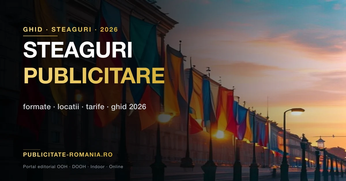 Steaguri publicitare drapele si lacrima pe stalpi iluminat in centrul unui bulevard din Bucuresti la apus